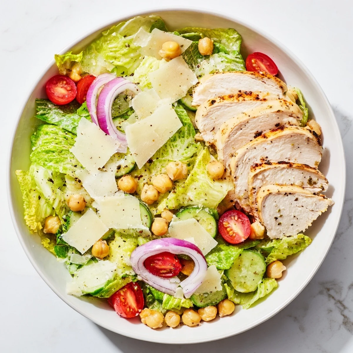 Close-up of a Chicken Caesar Pasta-less Bowl featuring fresh ingredients and flavorful Caesar dressing.