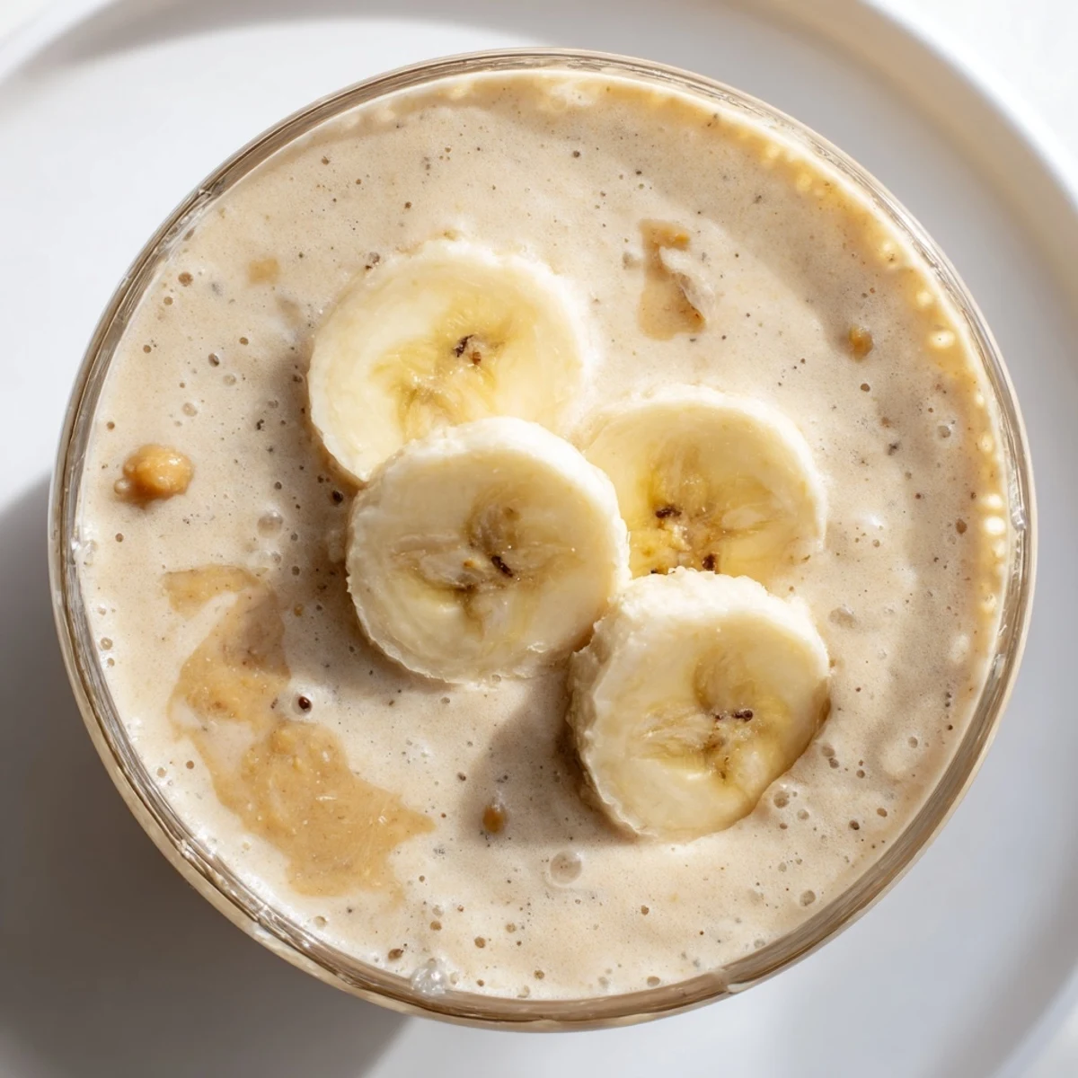 Creamy Peanut Butter Banana Smoothie, swirled in a glass, ready for a refreshing breakfast.
