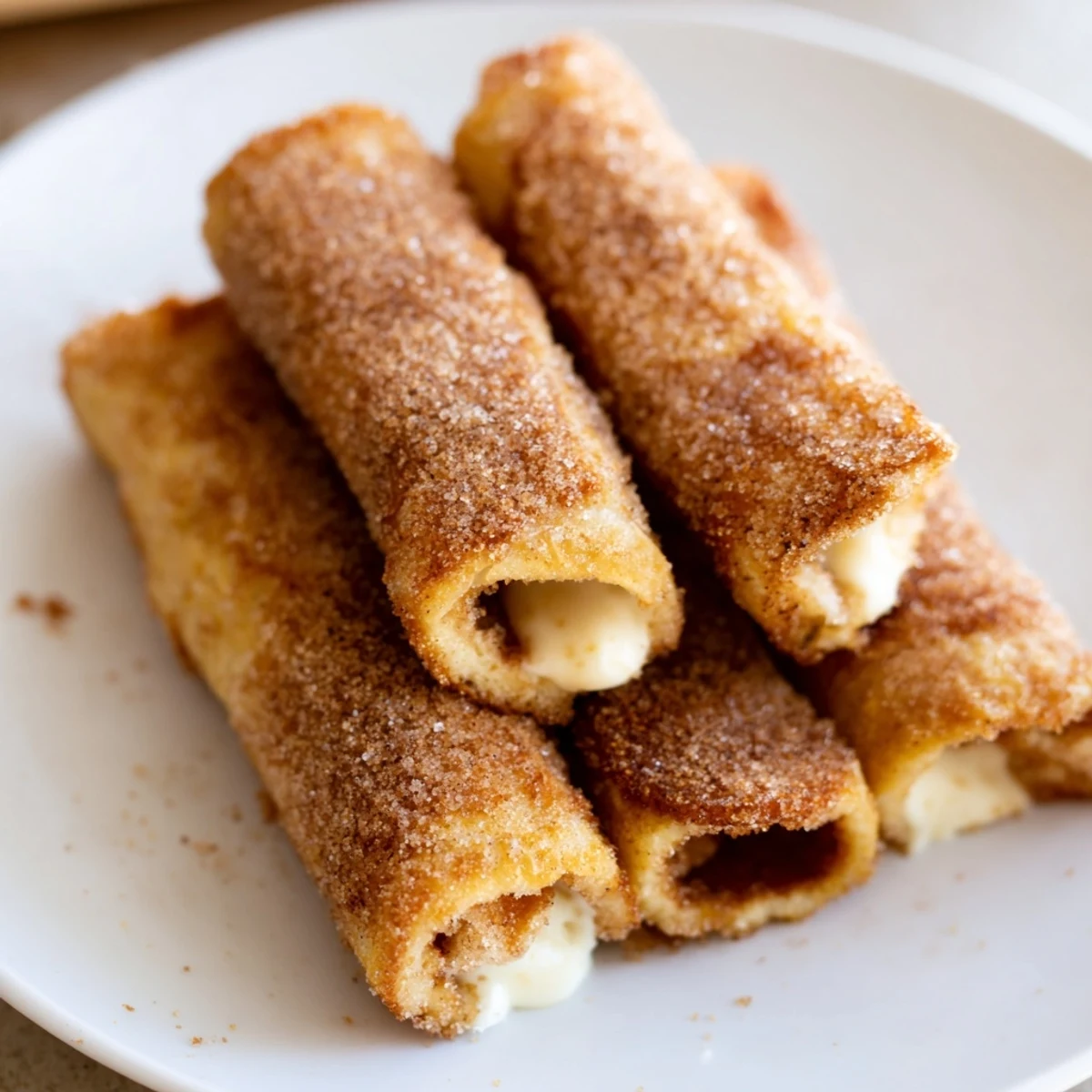 Golden, crispy Easy French Toast Roll-Ups, dusted in cinnamon sugar, perfect for a quick breakfast.
