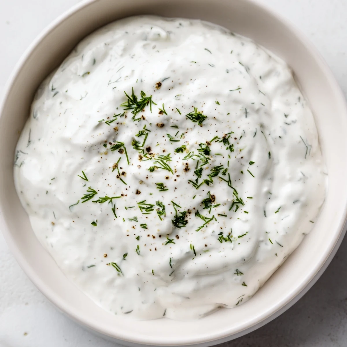 Creamy Greek Yogurt Ranch Dip, garnished with fresh herbs, ready to be scooped up with crunchy vegetables.