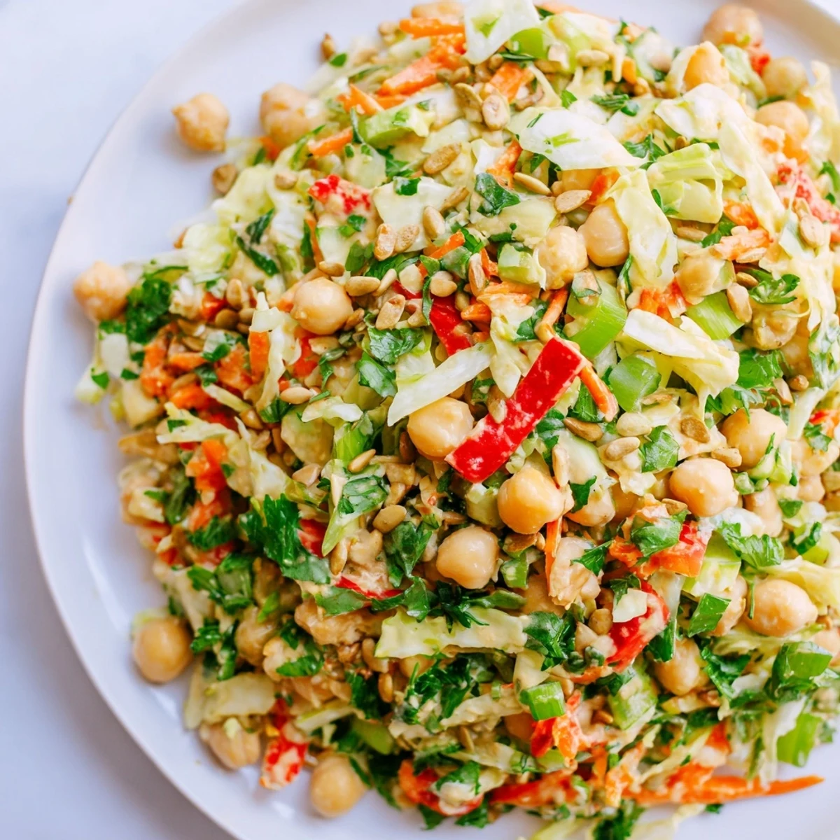 Vibrant Fiber-Forward Chickpea Salad showcasing colorful vegetables and creamy tahini dressing, perfect for lunch.
