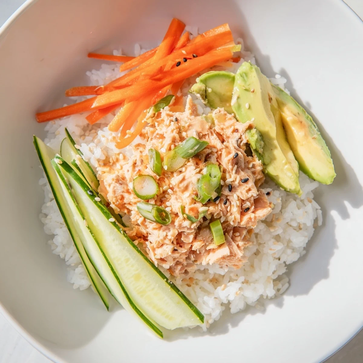 This image shows a beautifully arranged Spicy Canned Salmon Rice Bowl, ready for a quick and easy lunch.