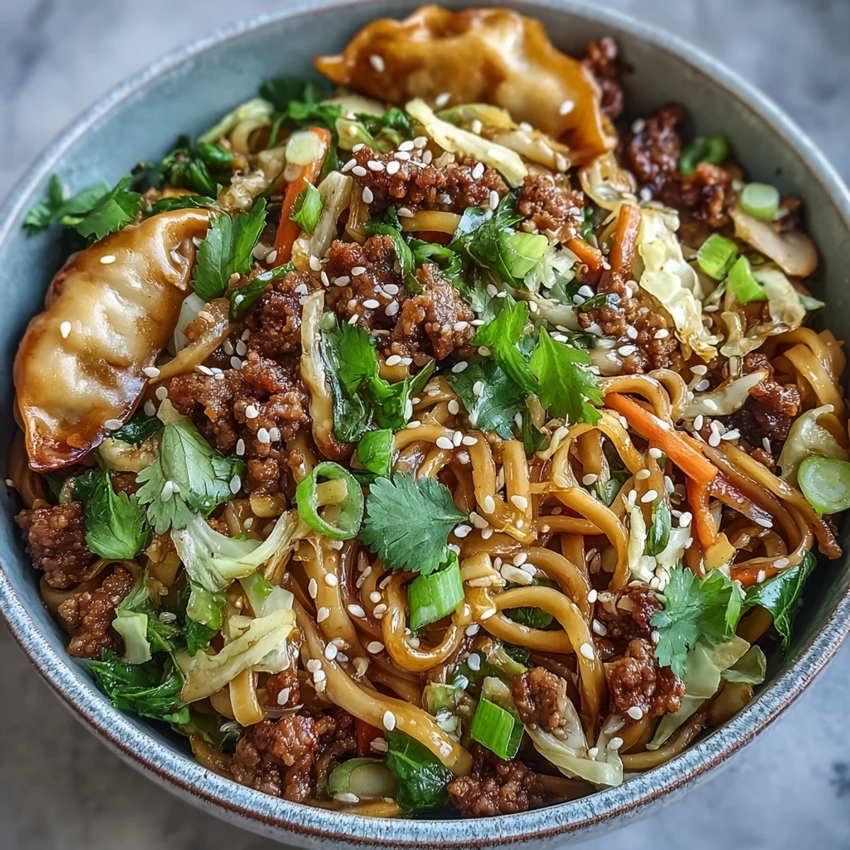 Close-up of savory potsticker noodles tossed with browned pork, bean sprouts, and vibrant carrots in a glossy, umami-rich sauce.