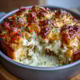 Golden pineapple chicken casserole with juicy fruit, tender chicken, and melted cheddar cheese on top.