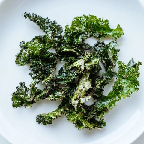 Oven-baked Crispy Kale Chips seasoned with smoky paprika, a fantastic vegan snack to enjoy.