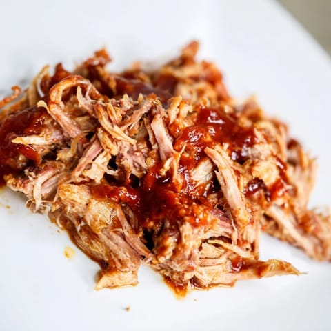 Close-up of slow-cooked 5-Ingredient BBQ Pulled Pork, ready to be pulled and tossed.