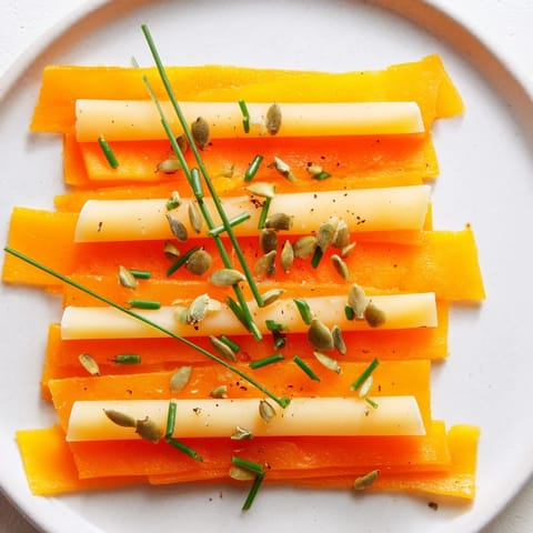 A visually appealing Serengeti Sunset appetizer with colorful bands of fruit and cheese, ready to eat.