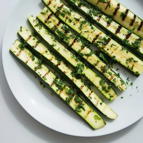 Golden brown Garlic Herb Grilled Zucchini slices, ready to serve as a delicious Mediterranean side.