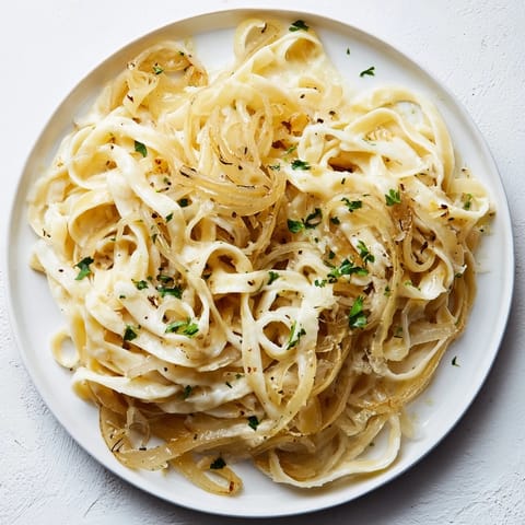 Creamy One-Pot French Onion Pasta, topped with melted Gruyère, ready for a comforting dinner.