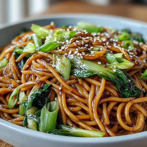 Silky wheat noodles tossed in savory ginger-scallion sauce, topped with tender baby bok choy and snap peas.  