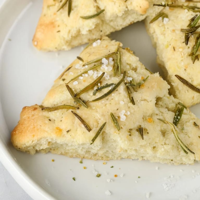 Freshly baked Yeast-Free Garlic and Rosemary Bannock Bread, warm and fragrant serving suggestion with savory soup.