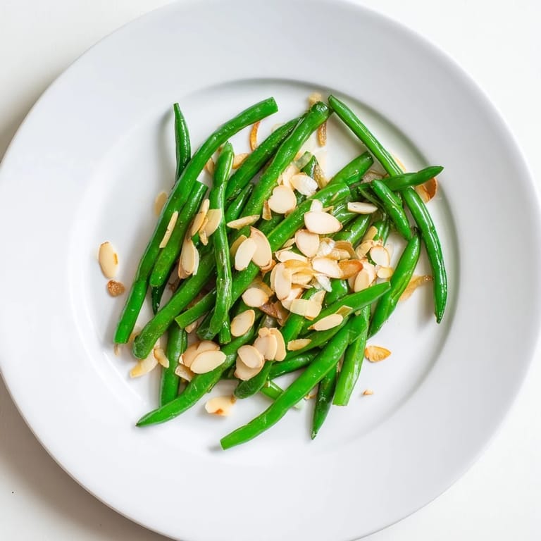 Enjoy the visually stunning Sautéed Green Beans, glistening with olive oil and toasted almonds.