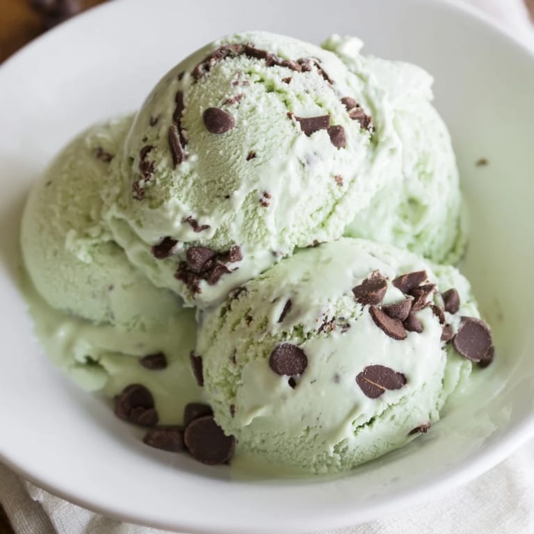 A scoopable bowl of delicious Mint Chocolate Chip Ice Cream, perfect for a summer dessert craving.