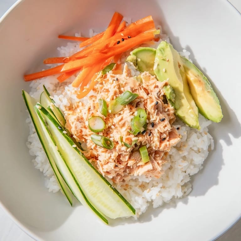 This image shows a beautifully arranged Spicy Canned Salmon Rice Bowl, ready for a quick and easy lunch.
