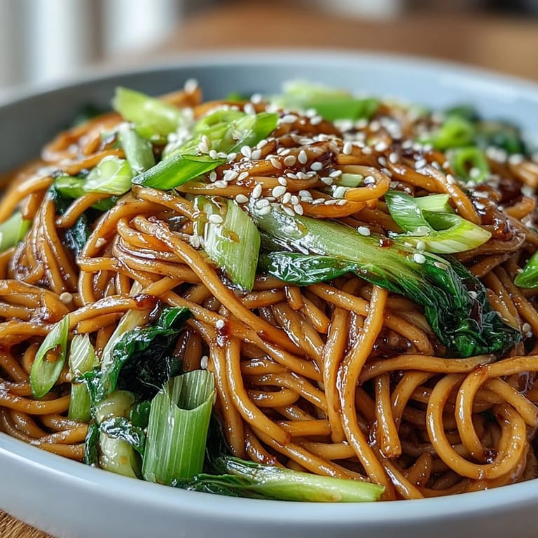 Silky wheat noodles tossed in savory ginger-scallion sauce, topped with tender baby bok choy and snap peas.  