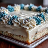 Festive vanilla sheet cake with Class of 2026 piping, decorated in school colors and buttercream swirls for graduation.